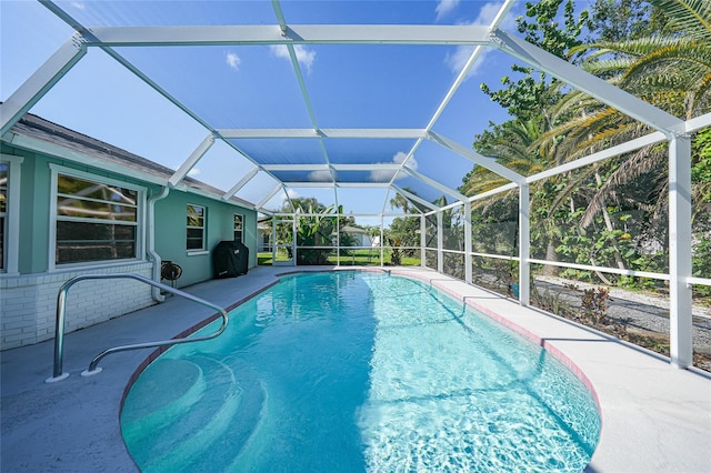 7453 Spinnaker Blvd, Englewood, FL 34224 - outdoor pool with glass enclosure, a patio area, and a grill