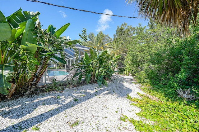 7453 Spinnaker Blvd, Englewood, FL 34224 - view of yard featuring an outdoor pool and glass enclosure