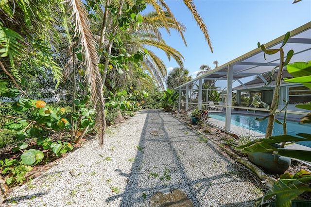 7453 Spinnaker Blvd, Englewood, FL 34224 - view of yard featuring an outdoor pool and glass enclosure