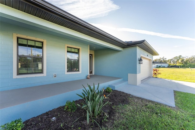 184 Spring Dr, Rotonda West, FL 33947 - view of side of property featuring covered porch, a garage, a lawn, and driveway