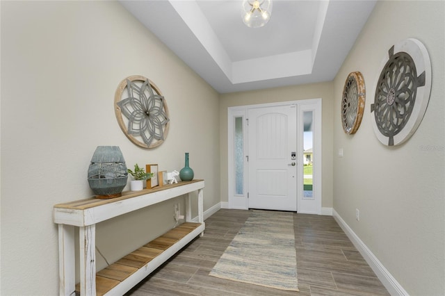 184 Spring Dr, Rotonda West, FL 33947 - entryway featuring wood finished floors and a tray ceiling