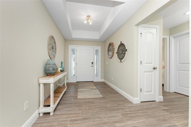 184 Spring Dr, Rotonda West, FL 33947 - entryway featuring light wood-style flooring and a raised ceiling