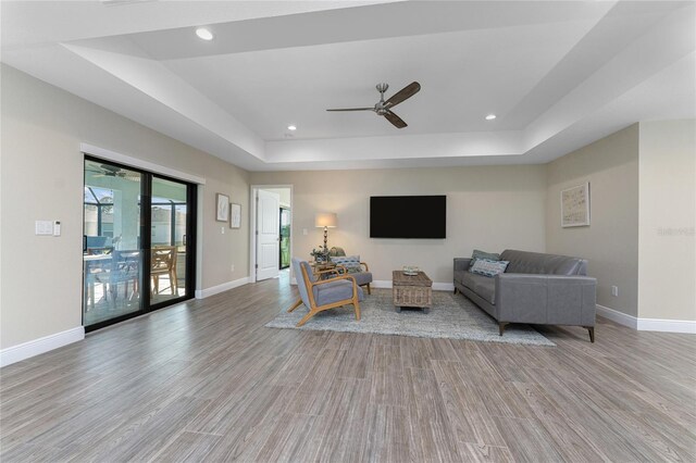 184 Spring Dr, Rotonda West, FL 33947 - living area featuring a raised ceiling, wood finished floors, ceiling fan, and recessed lighting