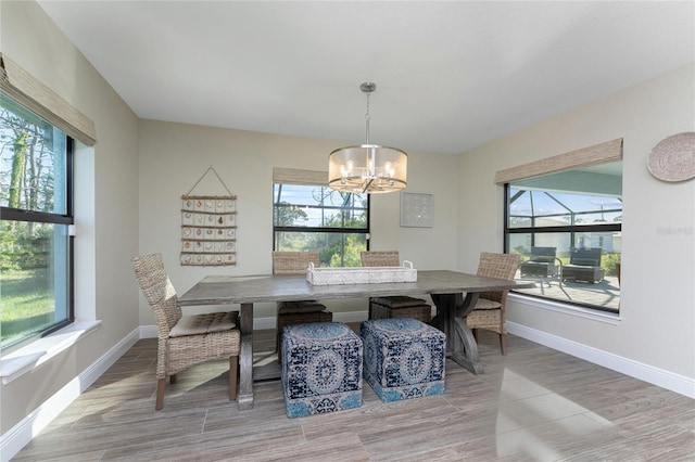 184 Spring Dr, Rotonda West, FL 33947 - dining space featuring a chandelier and wood finished floors