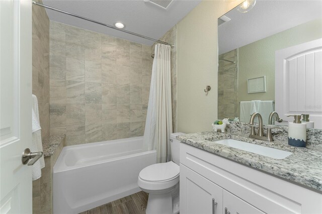 184 Spring Dr, Rotonda West, FL 33947 - bathroom with vanity, shower / bath combo with shower curtain, and wood finished floors