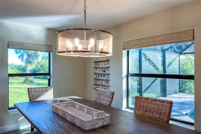 184 Spring Dr, Rotonda West, FL 33947 - dining area with a chandelier and wood finished floors