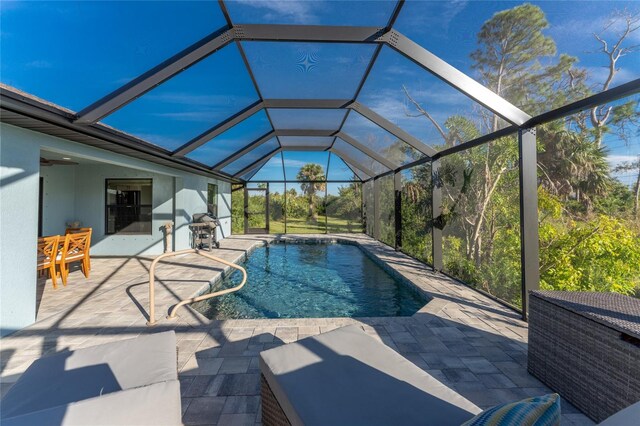 184 Spring Dr, Rotonda West, FL 33947 - swimming pool with a patio area and glass enclosure