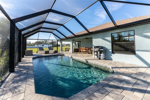 184 Spring Dr, Rotonda West, FL 33947 - swimming pool with a patio area, outdoor dining space, a ceiling fan, area for grilling, and glass enclosure