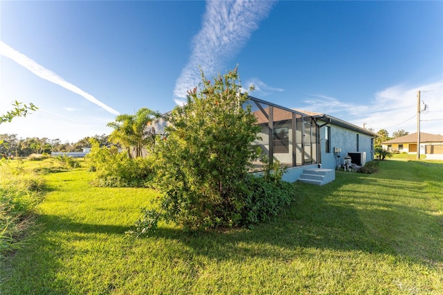 184 Spring Dr, Rotonda West, FL 33947 - view of grassy yard with a lanai