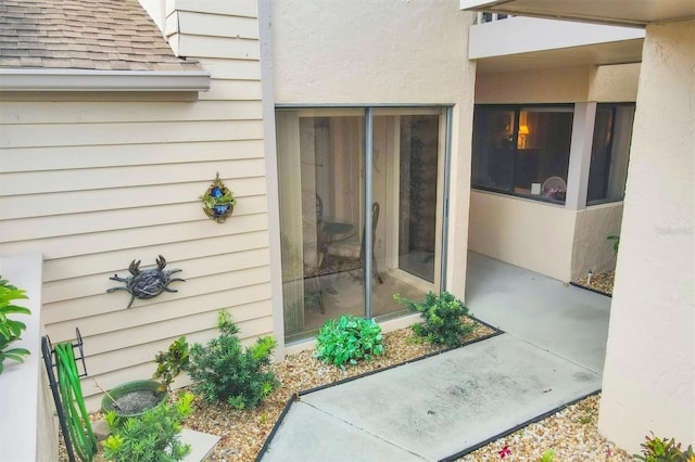 2004 Longpointe Cir Unit E2, Venice, FL 34293 - view of exterior entry with roof with shingles