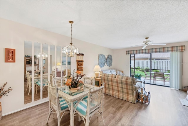 2004 Longpointe Cir Unit E2, Venice, FL 34293 - dining space featuring a chandelier, light wood-style floors, a ceiling fan, and a textured ceiling