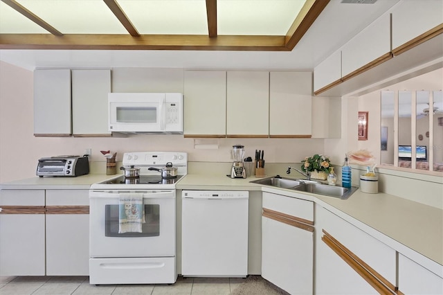 2004 Longpointe Cir Unit E2, Venice, FL 34293 - kitchen with white appliances, light countertops, light tile patterned floors, and white cabinets