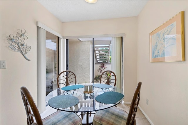 2004 Longpointe Cir Unit E2, Venice, FL 34293 - dining room with light tile patterned floors and a textured ceiling
