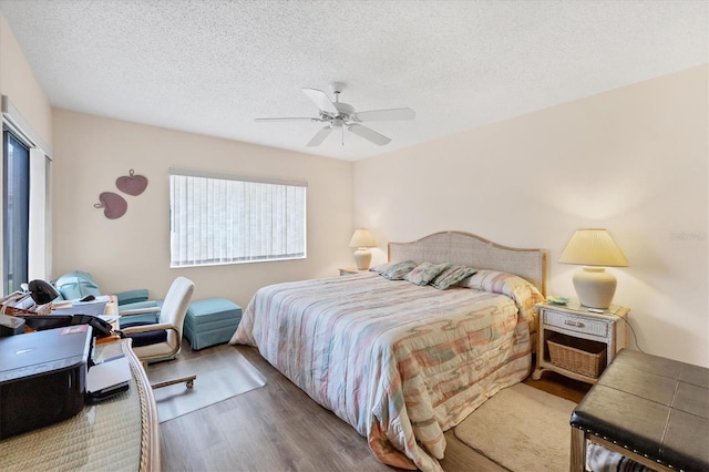 2004 Longpointe Cir Unit E2, Venice, FL 34293 - bedroom featuring wood finished floors, a textured ceiling, and ceiling fan