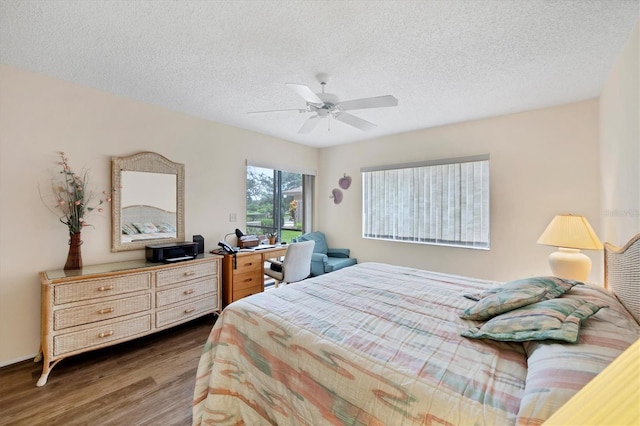 2004 Longpointe Cir Unit E2, Venice, FL 34293 - bedroom with wood finished floors, a textured ceiling, and a ceiling fan