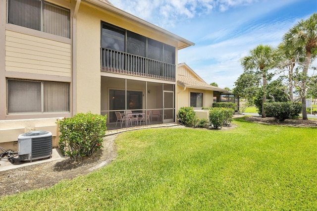 2004 Longpointe Cir Unit E2, Venice, FL 34293 - rear view of house featuring stucco siding and a yard