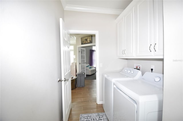 4354 Manatee Loop Unit 16A, Punta Gorda, FL 33950 - laundry room with cabinet space, washer and clothes dryer, crown molding, and wood tiled floors