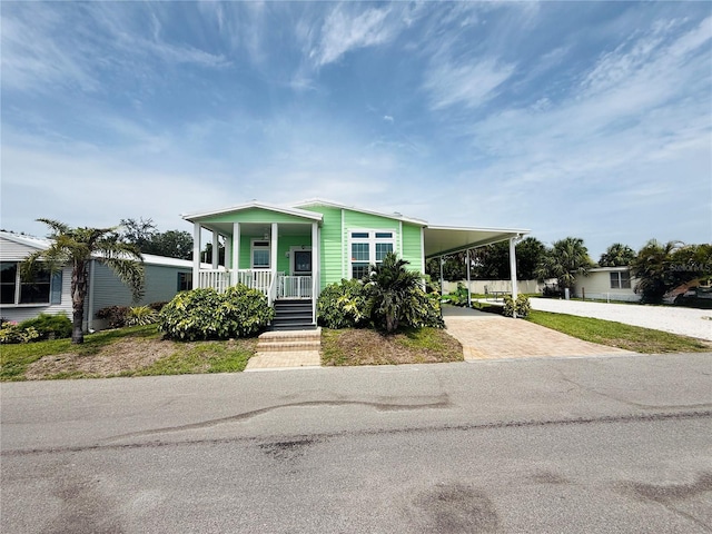 4354 Manatee Loop Unit 16A, Punta Gorda, FL 33950 - manufactured / mobile home with decorative driveway, covered porch, and an attached carport