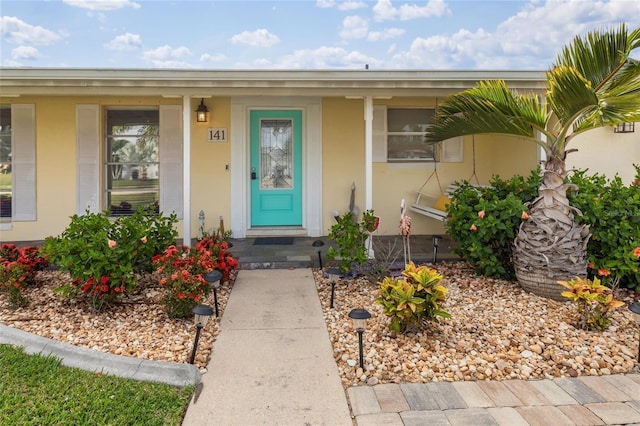 141 Baldwin Ct SE, Port Charlotte, FL 33952 - property entrance featuring stucco siding