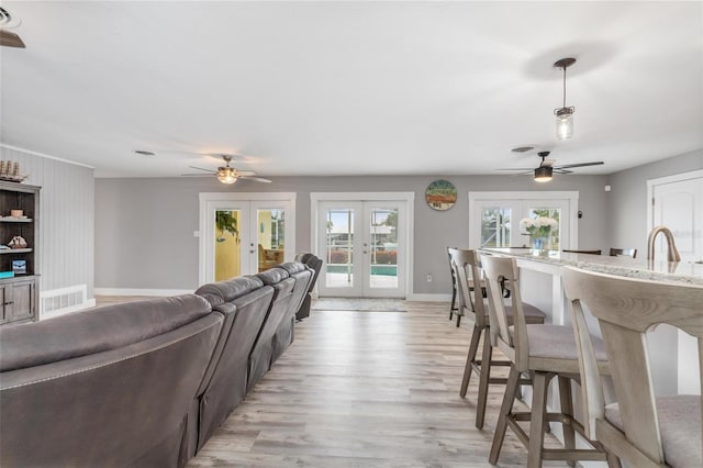 141 Baldwin Ct SE, Port Charlotte, FL 33952 - living area with ceiling fan, french doors, and light wood-type flooring