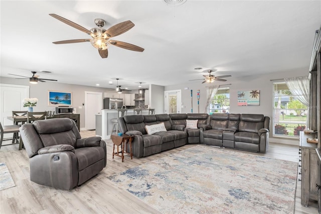 141 Baldwin Ct SE, Port Charlotte, FL 33952 - living room featuring a ceiling fan and light wood-style floors