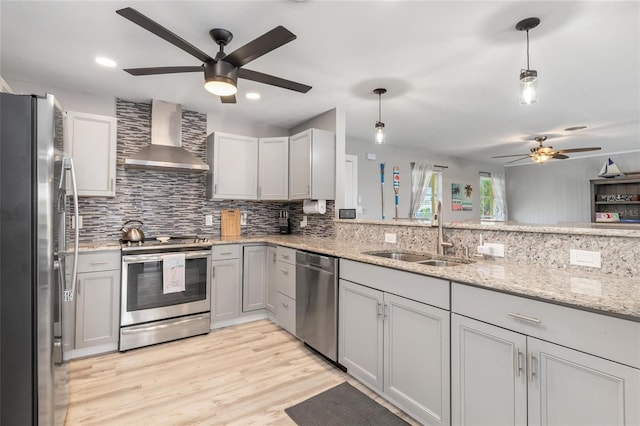141 Baldwin Ct SE, Port Charlotte, FL 33952 - kitchen with stainless steel appliances, wall chimney range hood, a ceiling fan, tasteful backsplash, and recessed lighting