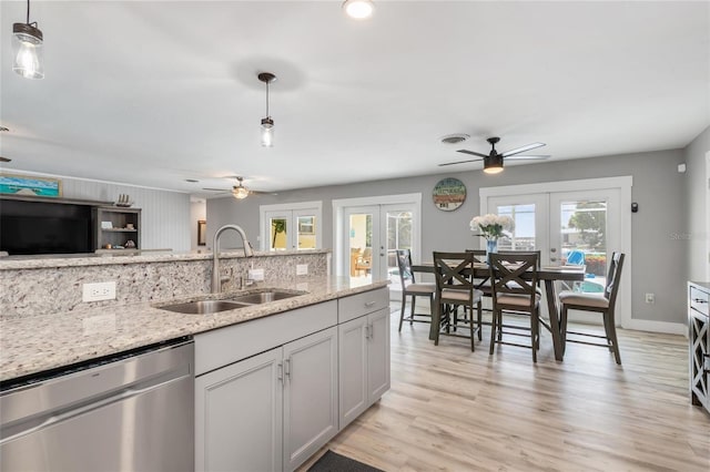 141 Baldwin Ct SE, Port Charlotte, FL 33952 - kitchen with french doors, dishwasher, a ceiling fan, light stone countertops, and recessed lighting