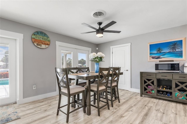 141 Baldwin Ct SE, Port Charlotte, FL 33952 - dining area with plenty of natural light, light wood-style floors, a ceiling fan, and french doors