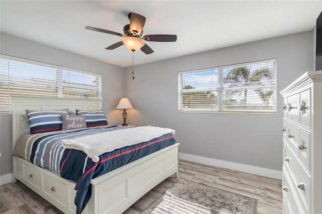 141 Baldwin Ct SE, Port Charlotte, FL 33952 - bedroom with multiple windows, light wood finished floors, and a ceiling fan