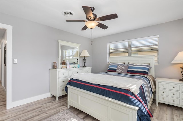 141 Baldwin Ct SE, Port Charlotte, FL 33952 - bedroom with multiple windows, light wood-style floors, and a ceiling fan
