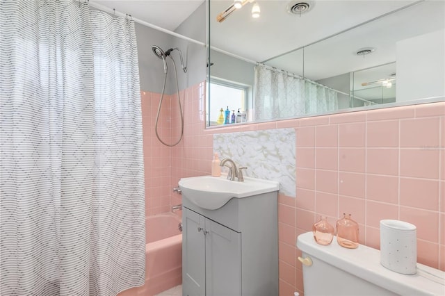 141 Baldwin Ct SE, Port Charlotte, FL 33952 - bathroom featuring shower / bath combo with shower curtain, tile walls, vanity, and decorative backsplash
