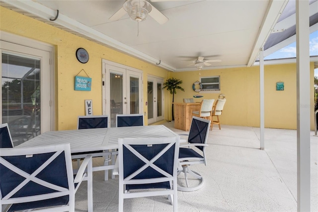 141 Baldwin Ct SE, Port Charlotte, FL 33952 - view of patio / terrace featuring french doors, ceiling fan, an AC wall unit, and outdoor dining area
