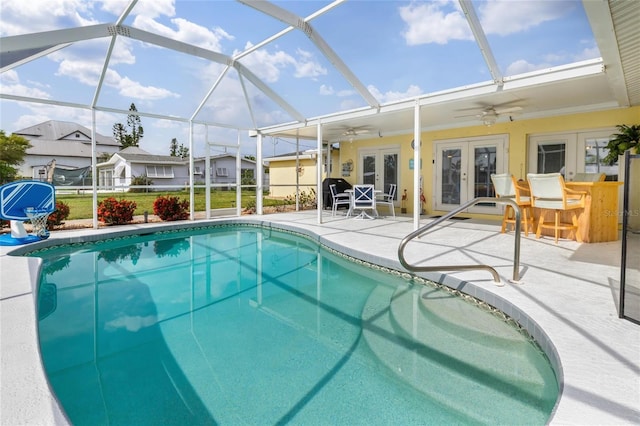 141 Baldwin Ct SE, Port Charlotte, FL 33952 - outdoor pool with french doors, a patio, a ceiling fan, and glass enclosure