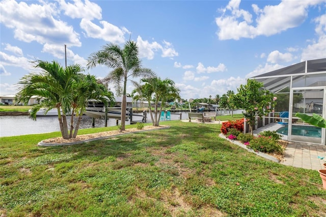141 Baldwin Ct SE, Port Charlotte, FL 33952 - view of green lawn with a water view, an outdoor pool, and glass enclosure