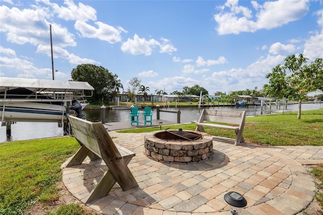 141 Baldwin Ct SE, Port Charlotte, FL 33952 - view of patio featuring a boat dock, a water view, an outdoor fire pit, and boat lift