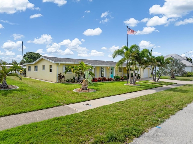 141 Baldwin Ct SE, Port Charlotte, FL 33952 - ranch-style house featuring a garage, a front yard, concrete driveway, and stucco siding