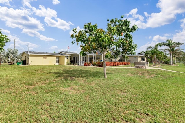 141 Baldwin Ct SE, Port Charlotte, FL 33952 - rear view of house featuring a lawn and stucco siding