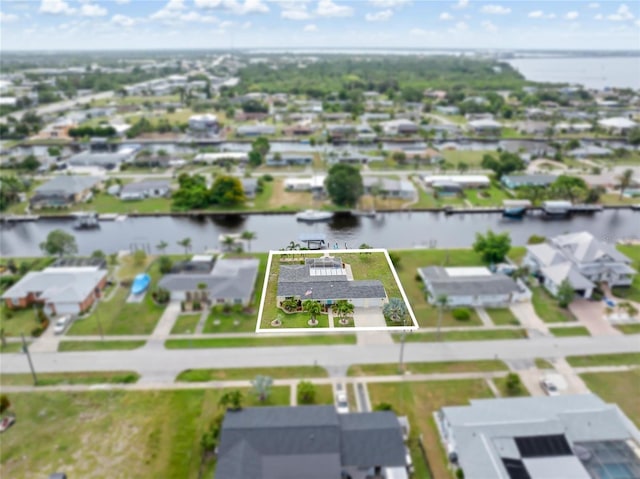 141 Baldwin Ct SE, Port Charlotte, FL 33952 - aerial view of residential area with property boundaries highlighted and a large body of water