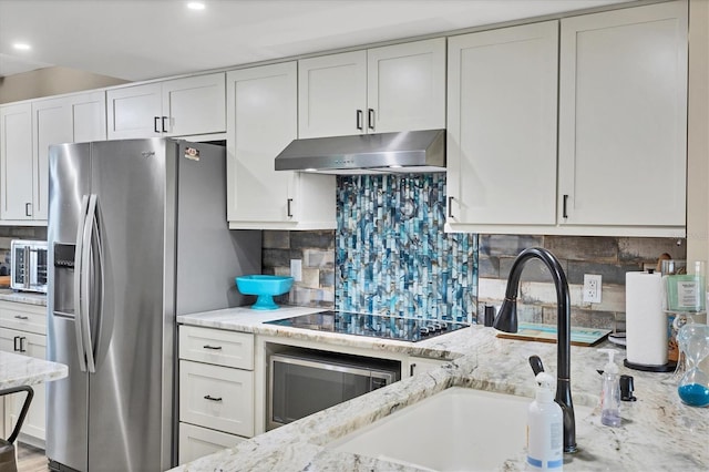 1401 S Mccall Rd Unit 205B, Englewood, FL 34223 - kitchen featuring under cabinet range hood, stainless steel appliances, light stone countertops, decorative backsplash, and recessed lighting