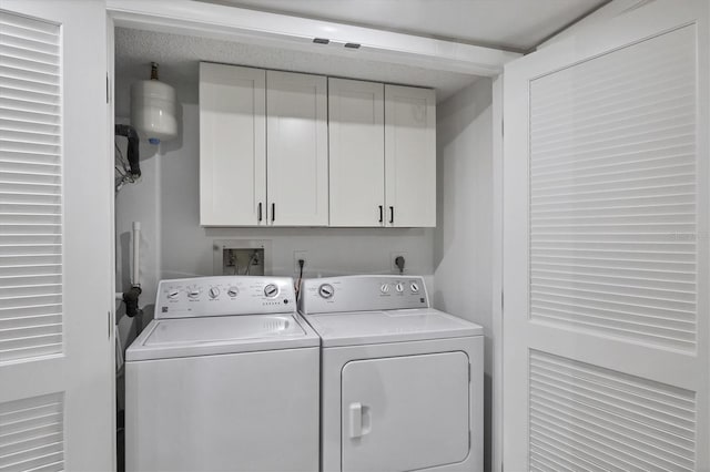 1401 S Mccall Rd Unit 205B, Englewood, FL 34223 - washroom featuring cabinet space and washer and clothes dryer