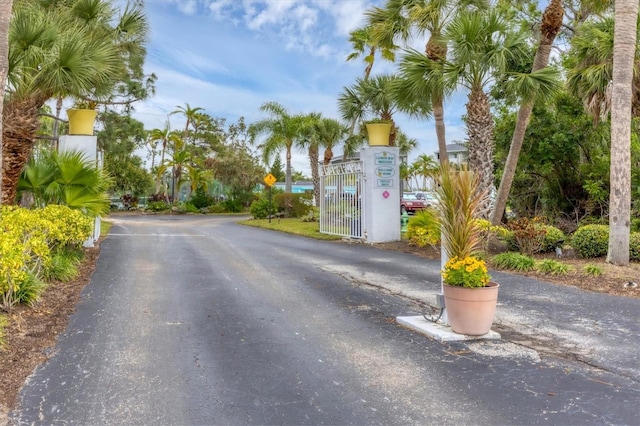 1401 S Mccall Rd Unit 205B, Englewood, FL 34223 - view of asphalt road with traffic signs and a gate