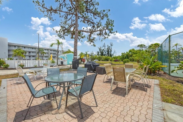 1401 S Mccall Rd Unit 205B, Englewood, FL 34223 - view of patio featuring outdoor dining area and grilling area