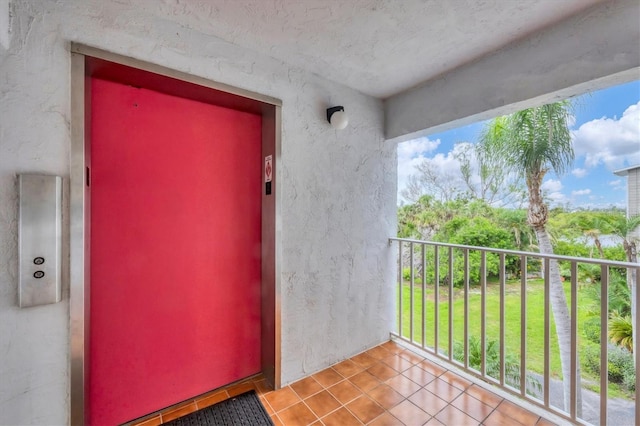 1401 S Mccall Rd Unit 205B, Englewood, FL 34223 - doorway to property with elevator, a balcony, and stucco siding