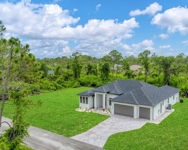 14089 Wenzel Ave, Port Charlotte, FL 33981 - view of front facade with a garage, decorative driveway, a front lawn, roof with shingles, and stucco siding