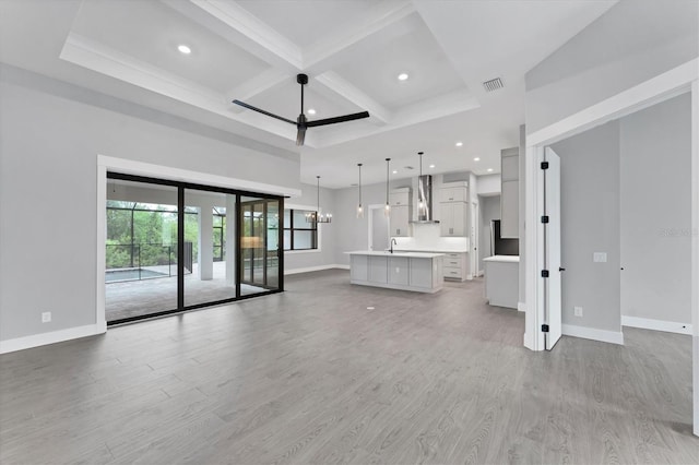 14089 Wenzel Ave, Port Charlotte, FL 33981 - unfurnished living room with beamed ceiling, light wood-style flooring, coffered ceiling, and recessed lighting