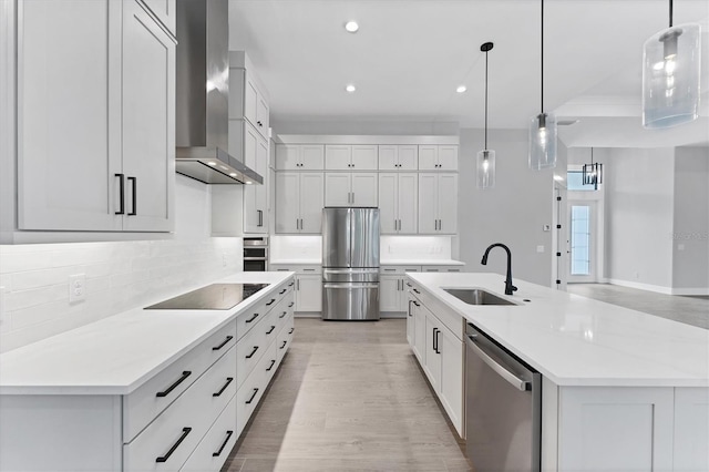 14089 Wenzel Ave, Port Charlotte, FL 33981 - kitchen with appliances with stainless steel finishes, wall chimney exhaust hood, decorative backsplash, recessed lighting, and light wood-style floors