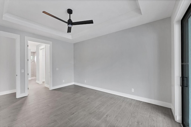 14089 Wenzel Ave, Port Charlotte, FL 33981 - spare room with a raised ceiling, ceiling fan, and dark wood finished floors