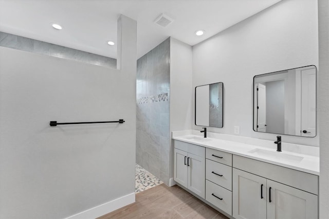 14089 Wenzel Ave, Port Charlotte, FL 33981 - bathroom featuring double vanity, wood finished floors, walk in shower, and recessed lighting