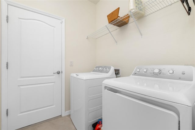 14756 Ponce De Leon Trl, Port Charlotte, FL 33981 - laundry area with washing machine and dryer and light tile patterned floors