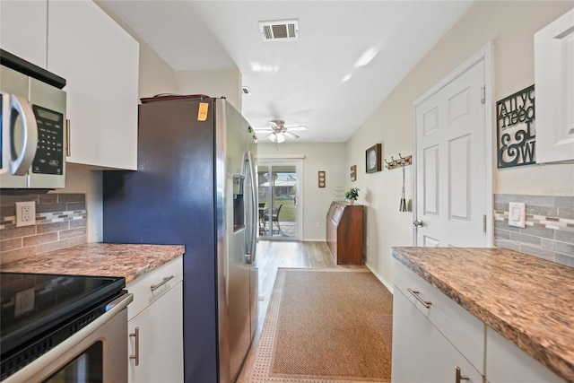7580 Hanchey St, North Port, FL 34287 - kitchen featuring appliances with stainless steel finishes, ceiling fan, tasteful backsplash, white cabinets, and light countertops